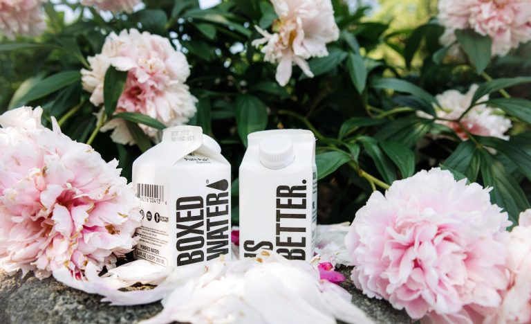 a couple of bottles that are next to some flowers